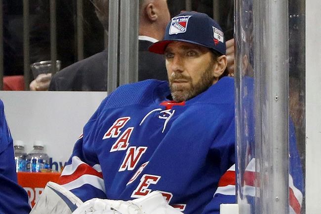 FILE - Then-New York Rangers goaltender Henrik Lundqvist looks on from the bench during an NHL hockey game against the Buffalo Sabres in New York, in this Friday, Feb. 7, 2020, file photo. Henrik Lundqvist is abandoning a long-shot attempt to return from open-heart surgery in time to play for the Washington Capitals this season after a checkup last week showed some inflammation. Lundqvist tweeted Sunday, April 11, 2021, that the inflammation around his heart requires a few months of rest and recovery. The 39-year-old goaltender had set the goal for himself of trying to join the Capitals before the end of the season. (AP Photo/Jim McIsaac, File)