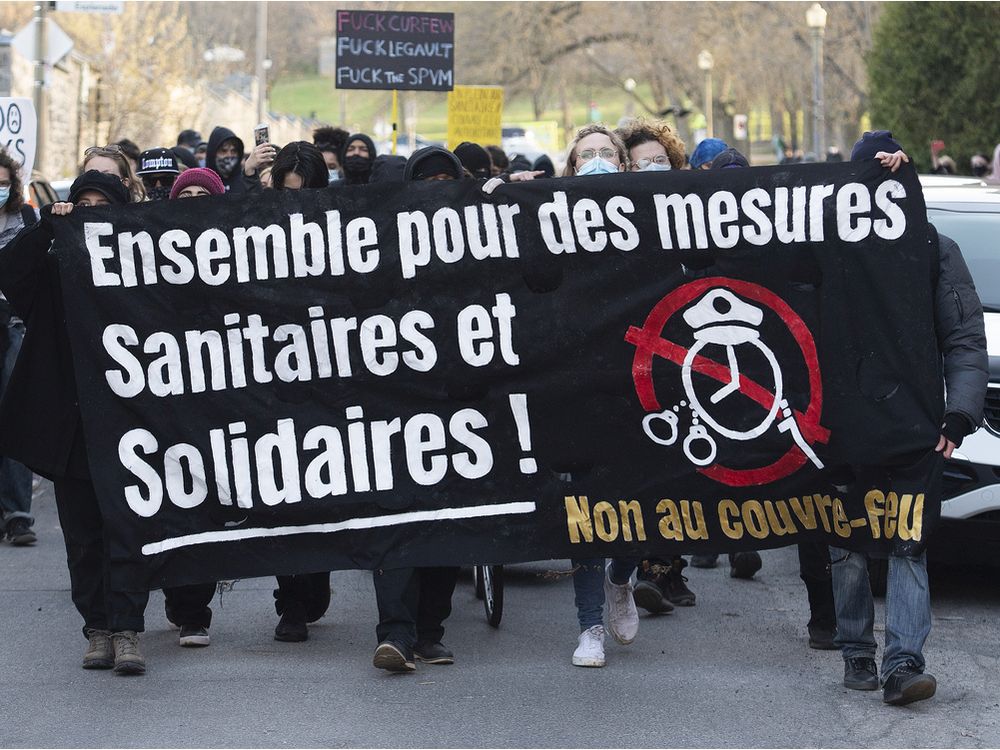 People take part in a demonstration opposing the Quebec government’s 8 p.m. curfew in Montreal, Sunday, April 18, 2021.